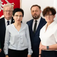 Sześć osób pozuje do zdjęcia, trzymając zielone teczki z napisem "Minister Rolnictwa i Rozwoju Wsi".